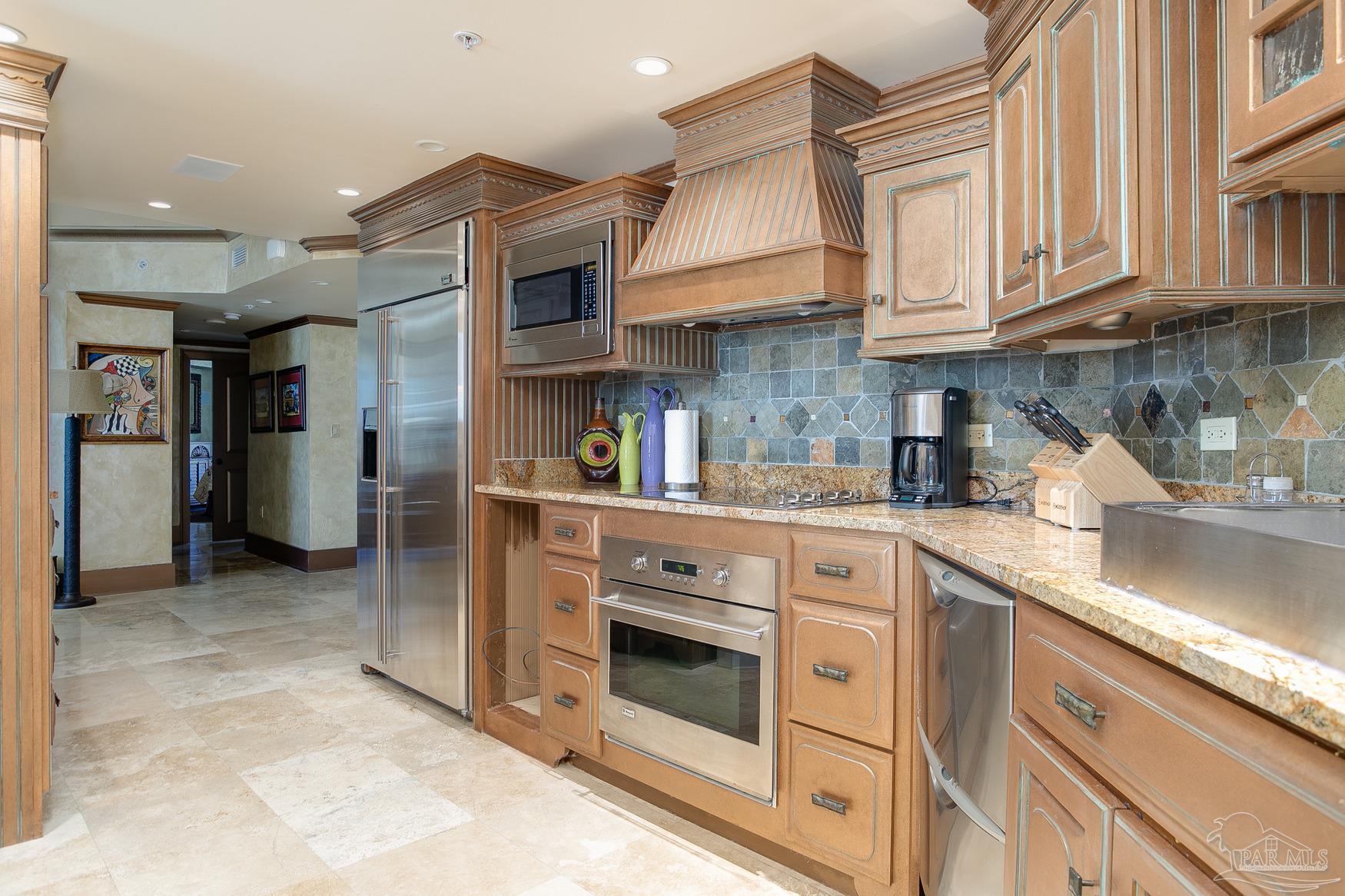 16795 Perdido Key Drive, Unit 40304B Perdido Key, FL 32507 - Photo 5 of 42 a kitchen with stainless steel appliances granite countertop a sink and cabinets