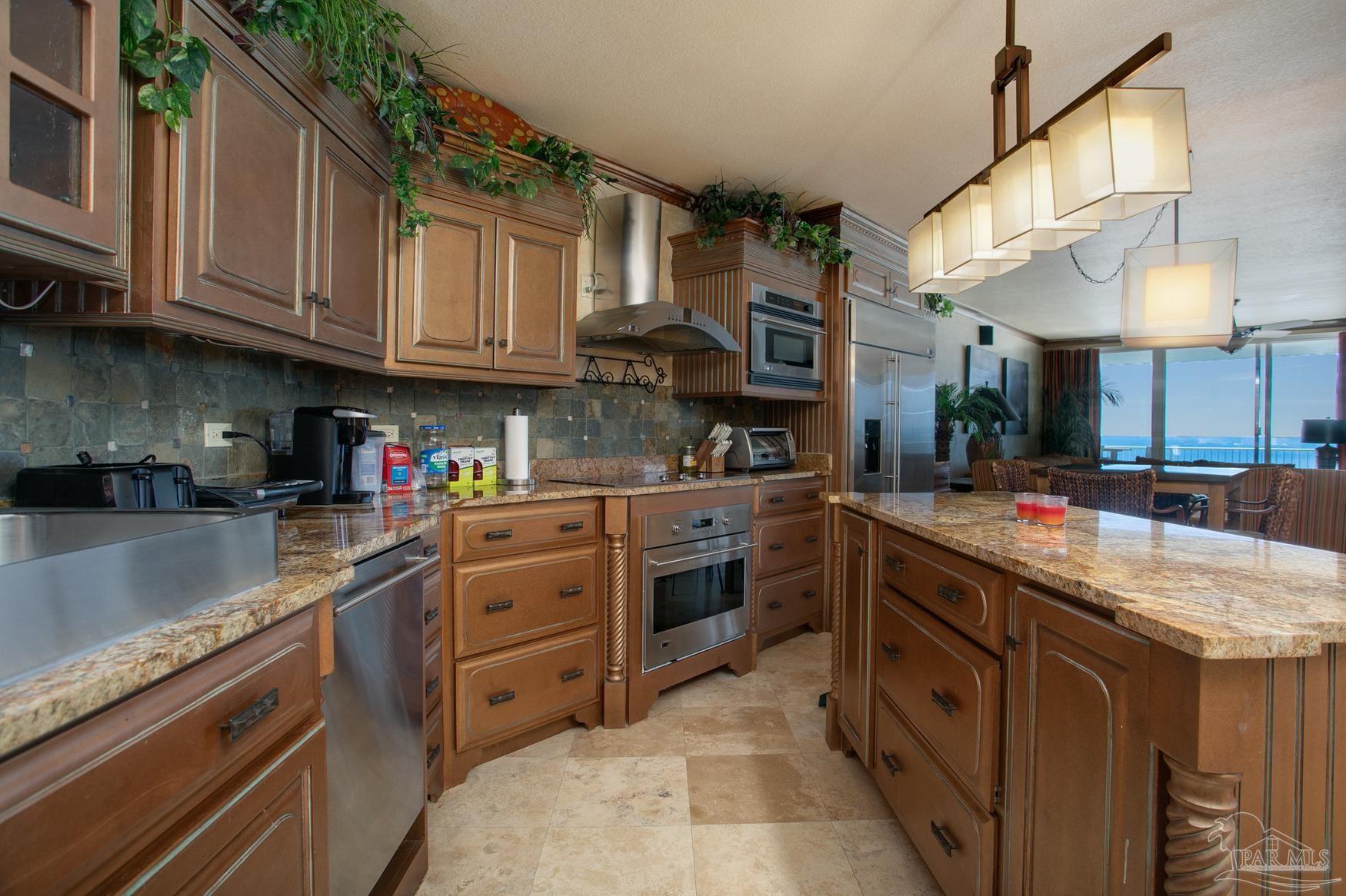 16795 Perdido Key Drive, Unit 40304B Perdido Key, FL 32507 - Photo 6 of 42 a kitchen with stainless steel appliances granite countertop a sink and cabinets