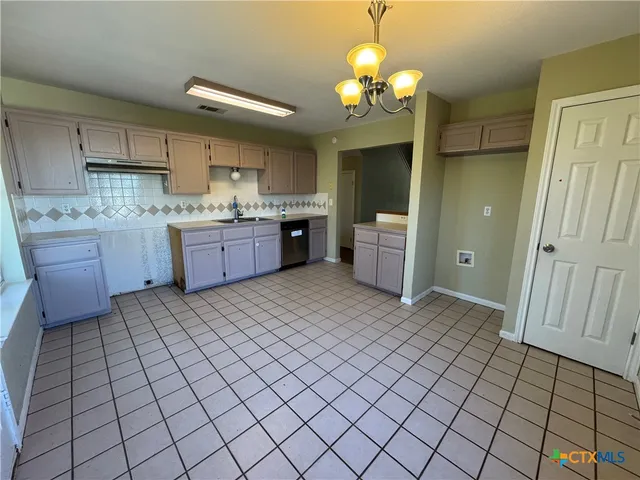 a kitchen with stainless steel appliances granite countertop a sink and cabinets