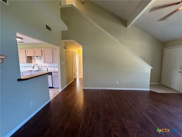 a view of a kitchen from a hallway