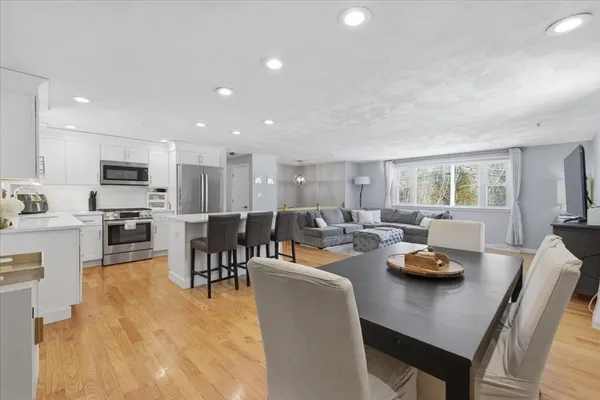 a living room with lots of furniture and kitchen view
