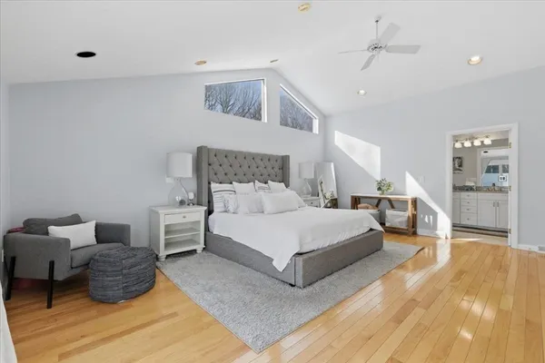 a spacious bedroom with a bed and ceiling fan