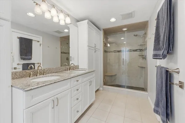 a bathroom with a granite countertop sink mirror and double