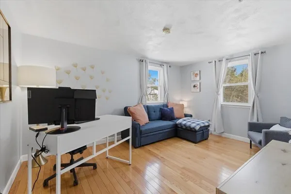 a living room with furniture and wooden floor