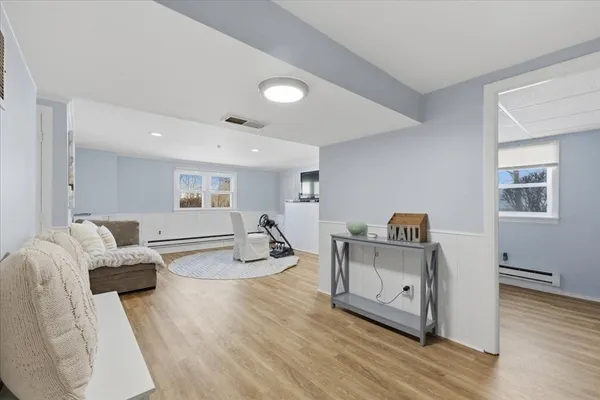 a living room with furniture and a wooden floor