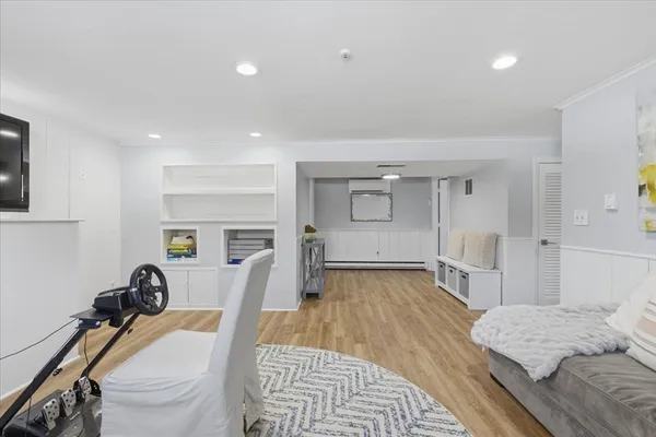 a bedroom with furniture and a wooden floor