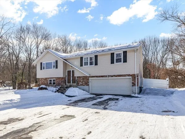 a view of a house with a yard covered in snow