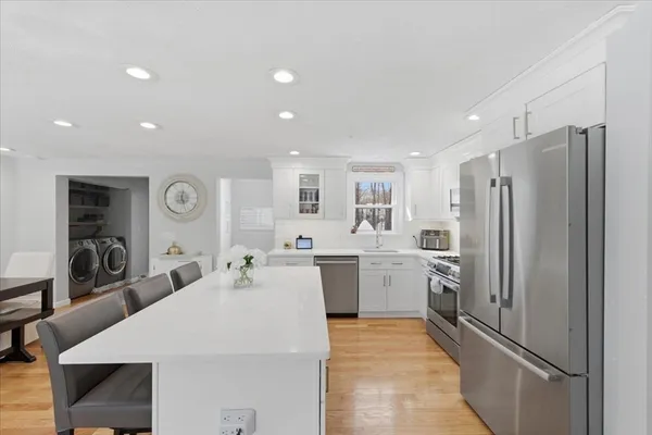 a kitchen with a refrigerator and a sink