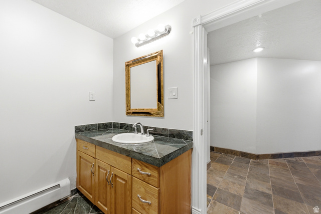 3535 Homestead Road Park City, UT 84098 - Photo 53 of 81 Bathroom vanity featuring a light wood cabinet, dark stone countertop, and a white undermount sink
