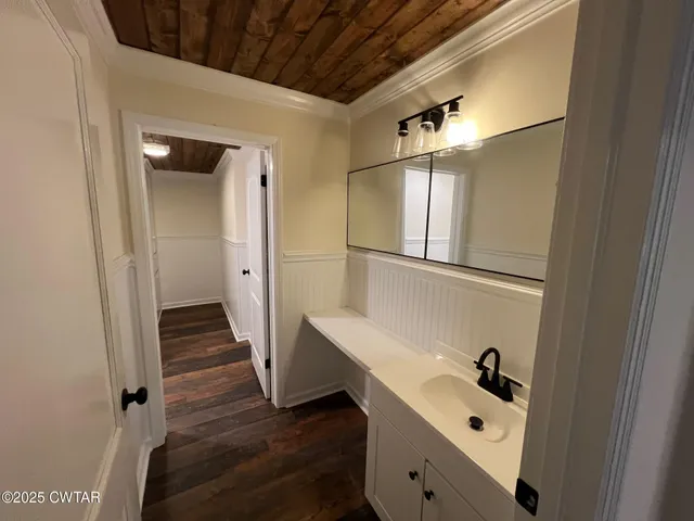 a bathroom with a sink and glass door