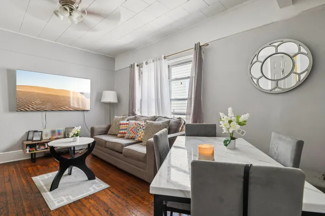 a living room with furniture a rug and a window