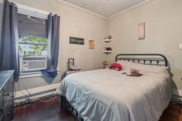 a bedroom with a bed and a window