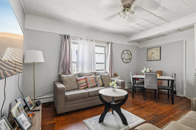 a living room with furniture a rug and a window