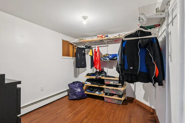 a view of walk in closet with clothes and shoes