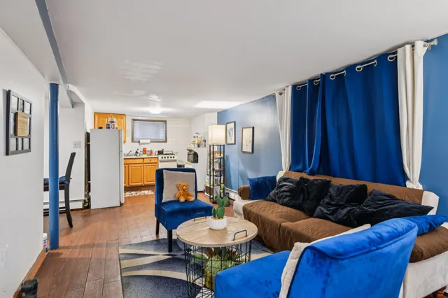 a living room with furniture and wooden floor