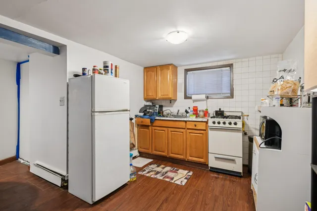 a kitchen with stainless steel appliances granite countertop a refrigerator sink and stove