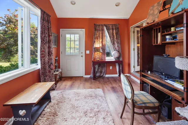 a view of a livingroom with furniture and a window