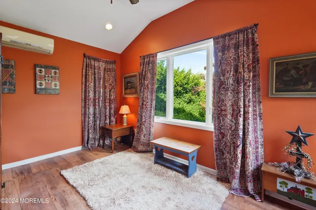 a living room with furniture a rug and a window