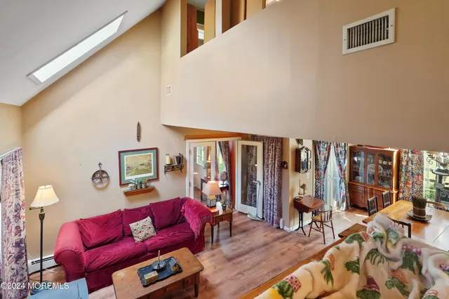 a living room with furniture a rug and a large window