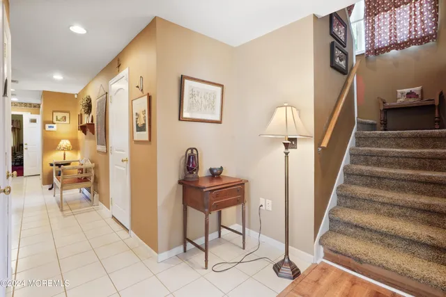 a view of a hallway with furniture and a chandelier