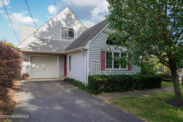 a front view of a house with a garden and plants