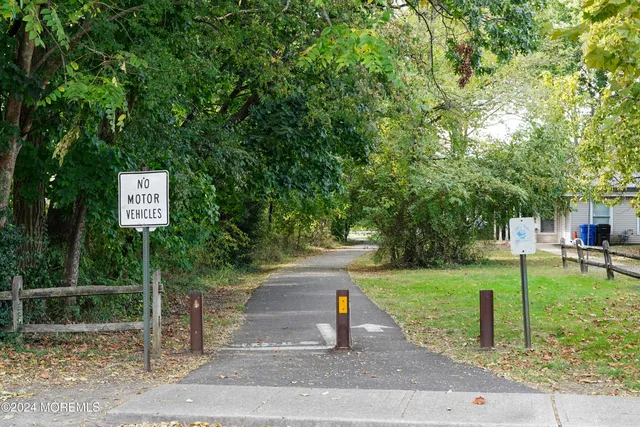 a sign board with yard in the back