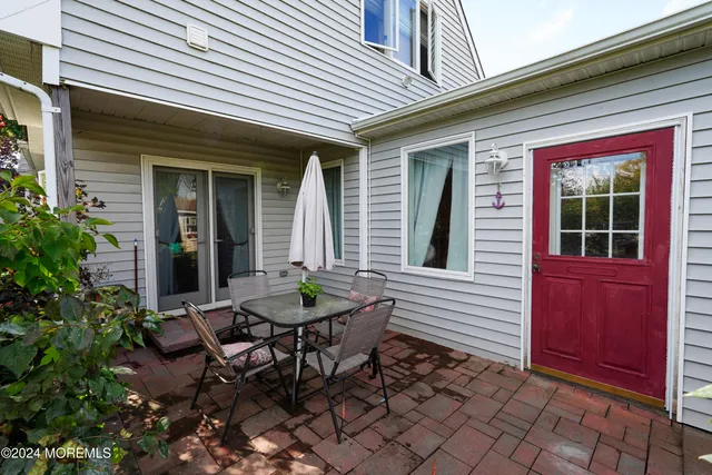 a table and chairs in front of a yard