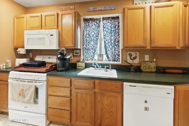a kitchen with stainless steel appliances granite countertop a sink and a cabinets
