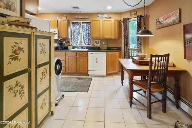 a kitchen with stainless steel appliances kitchen island granite countertop a table and chairs in it