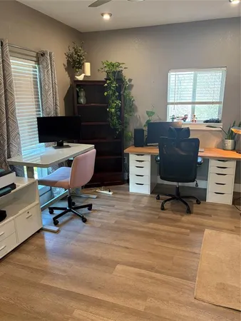 a view of a workspace with furniture and a window