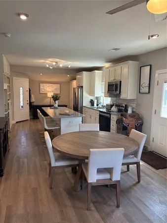 a large kitchen with a table and chairs in it