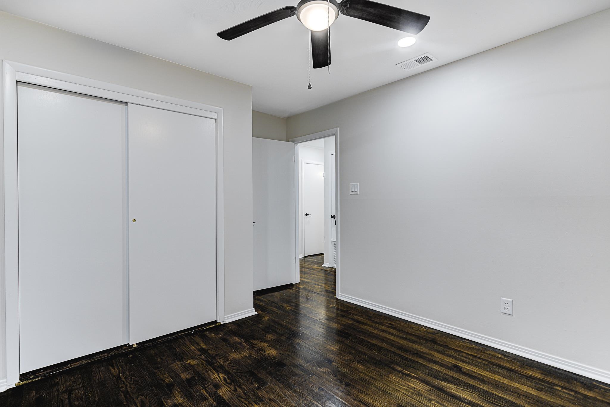 5094 Lochinvar Road Memphis, TN 38116 - Photo 12 of 23 Unfurnished bedroom with dark hardwood / wood-style flooring, a closet, and ceiling fan