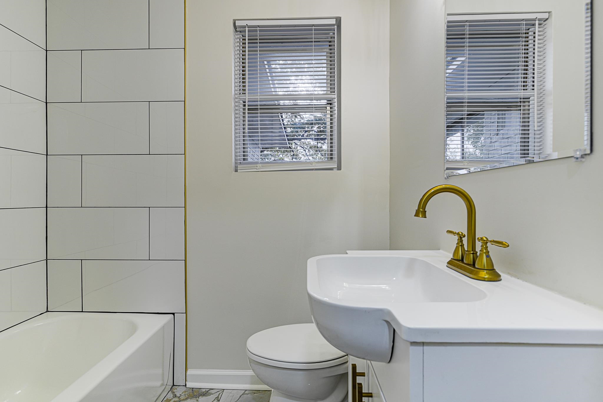 5094 Lochinvar Road Memphis, TN 38116 - Photo 17 of 23 Full Bathroom located in hallway featuring vanity, toilet, and plenty of natural light