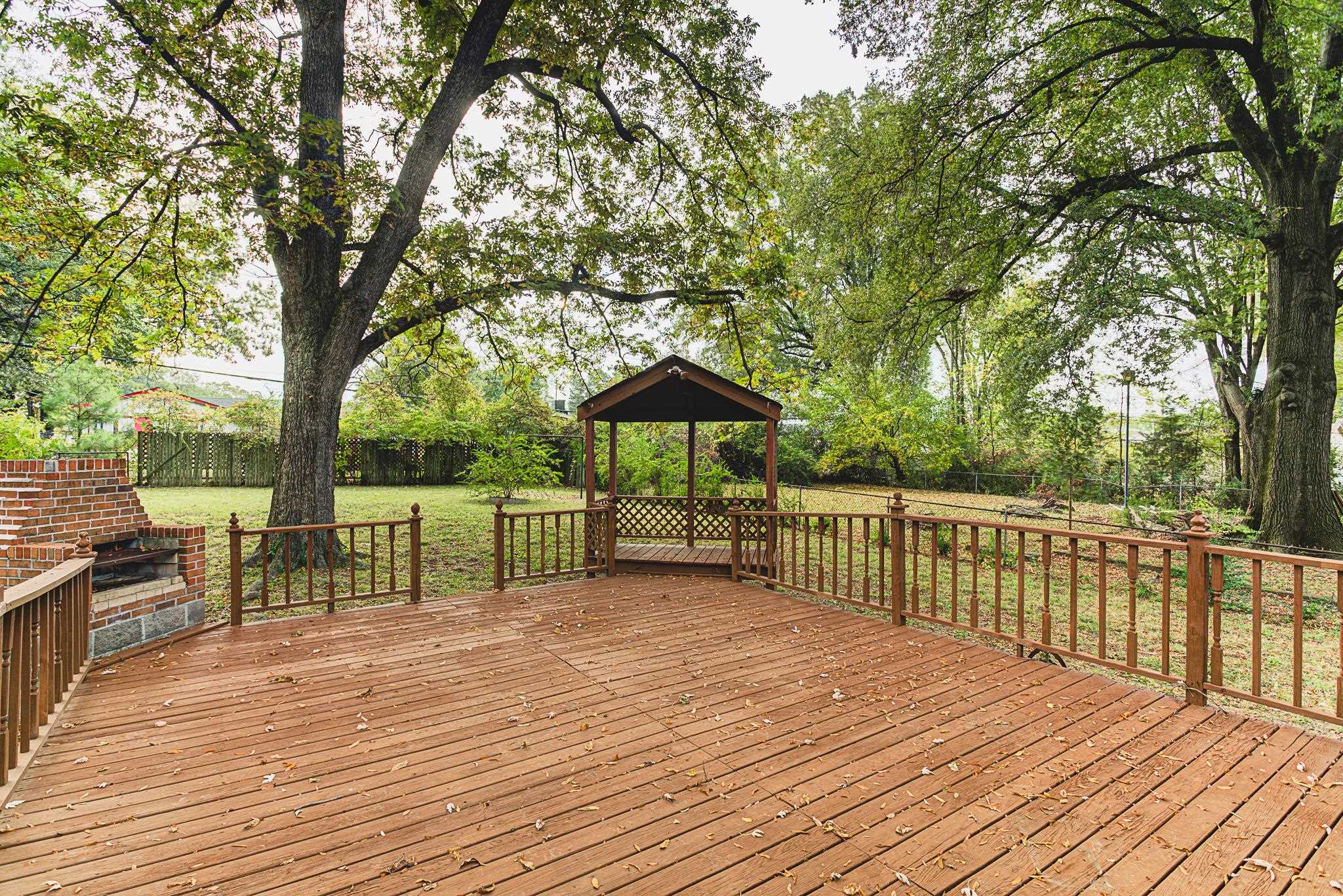 5094 Lochinvar Road Memphis, TN 38116 - Photo 19 of 23 Wooden deck featuring a gazebo and a lawn