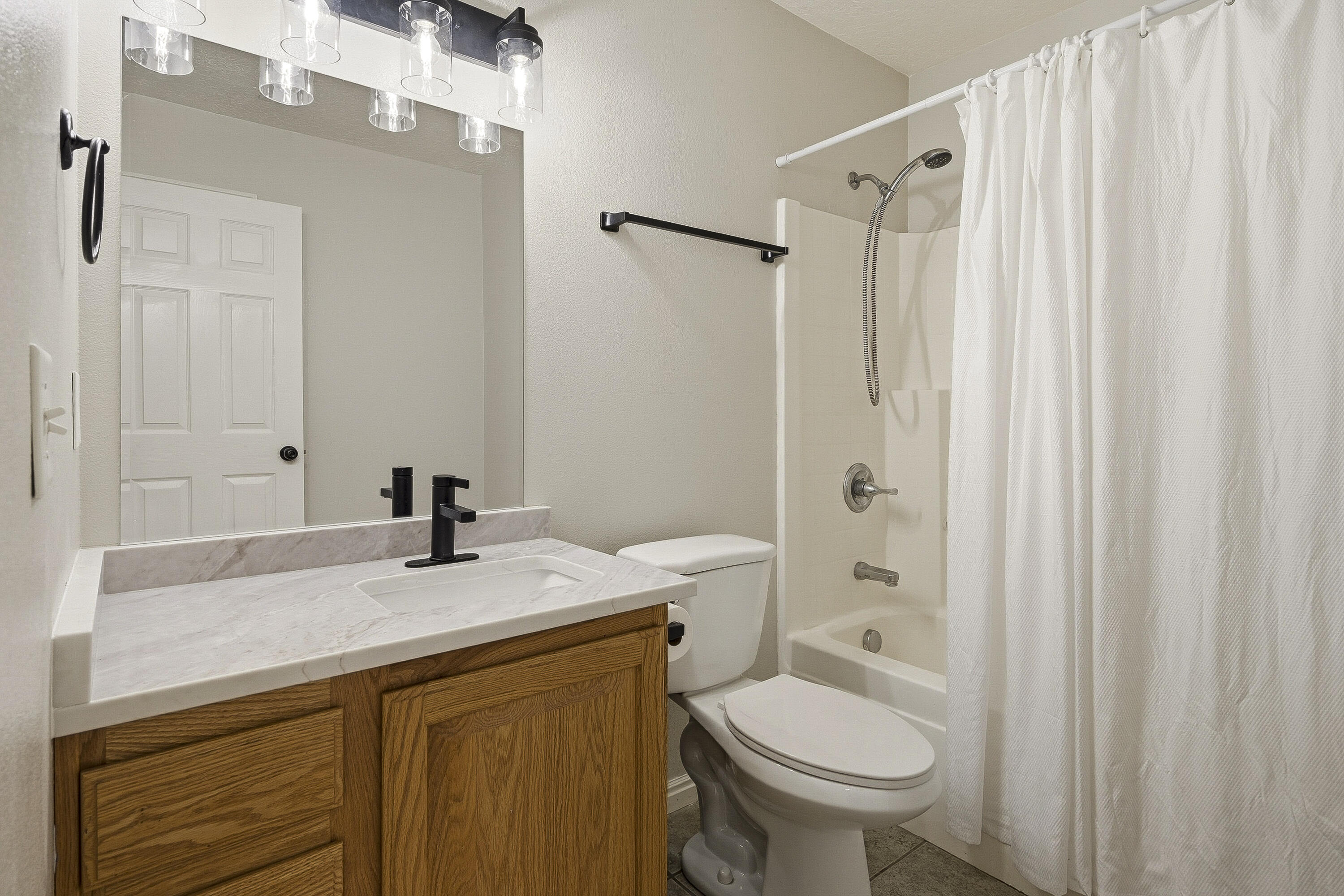 4510 North Half Mile Road Cedar City, UT 84721 - Photo 27 of 48 The secondary bathroom features an updated countertop and light fixture, tile flooring, and tub/shower combo.