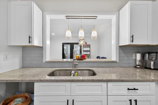a kitchen with a sink and cabinets