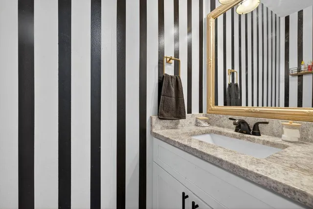 a bathroom with sink and a mirror