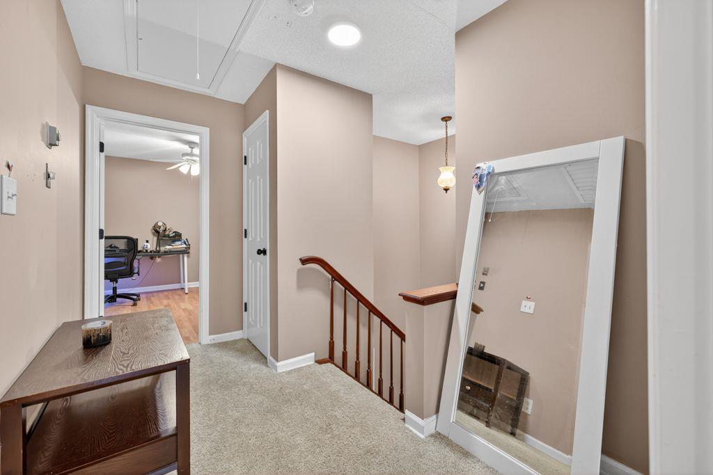 5970 WinterGreen Road Northwest Norcross, GA 30093 - Photo 16 of 34 a view of a hallway to a livingroom with wooden floor and furniture