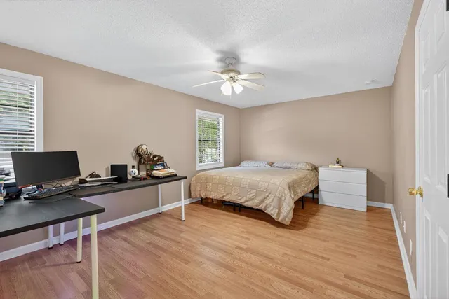 a bedroom with a bed and a desk