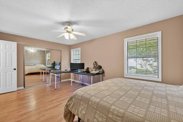a spacious bedroom with a bed and a chandelier