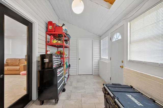 a kitchen view of a refrigerator and furniture