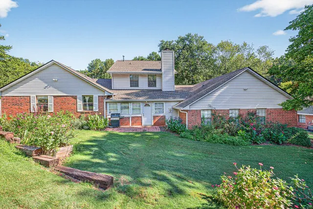 a front view of a house with a yard table and chairs