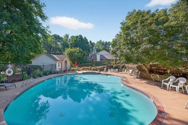 a swimming pool with outdoor seating and yard