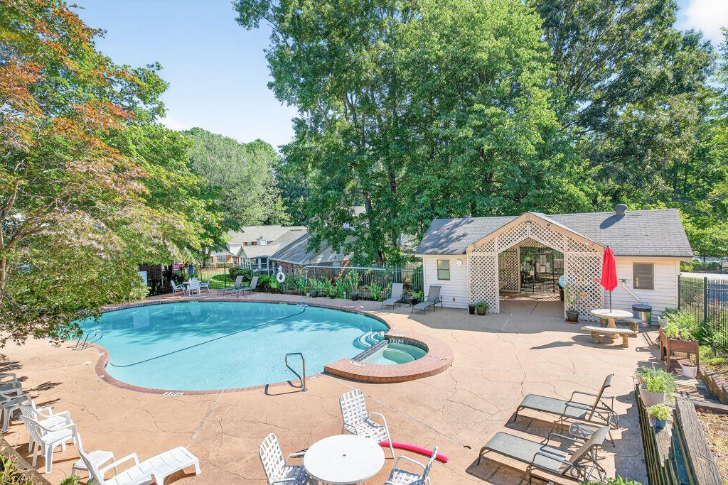5970 WinterGreen Road Northwest Norcross, GA 30093 - Photo 32 of 34 a view of a swimming pool with lawn chairs under an umbrella