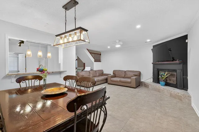 a living room with fireplace furniture and a chandelier