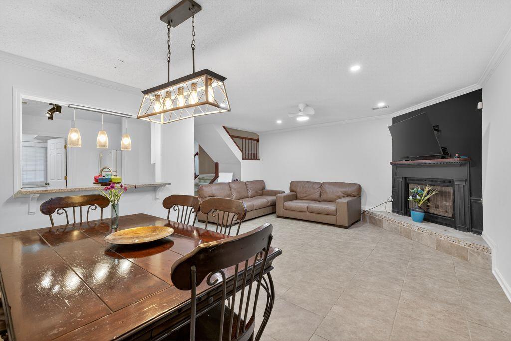 5970 WinterGreen Road Northwest Norcross, GA 30093 - Photo 9 of 34 a living room with fireplace furniture and a chandelier