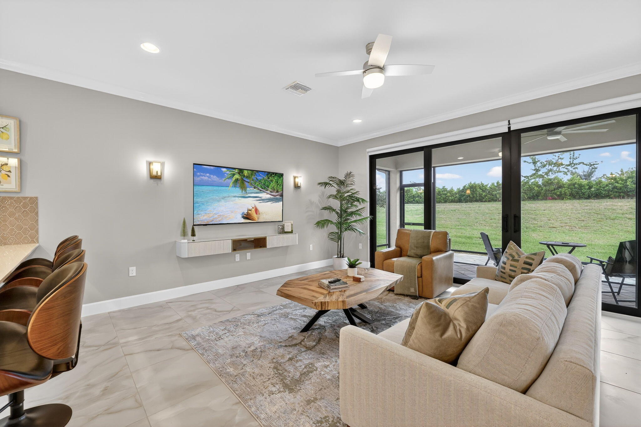 12447 Southwest Blue Mangrove Parkway Port St. Lucie, FL 34987 - Photo 11 of 80 a living room with furniture and a flat screen tv