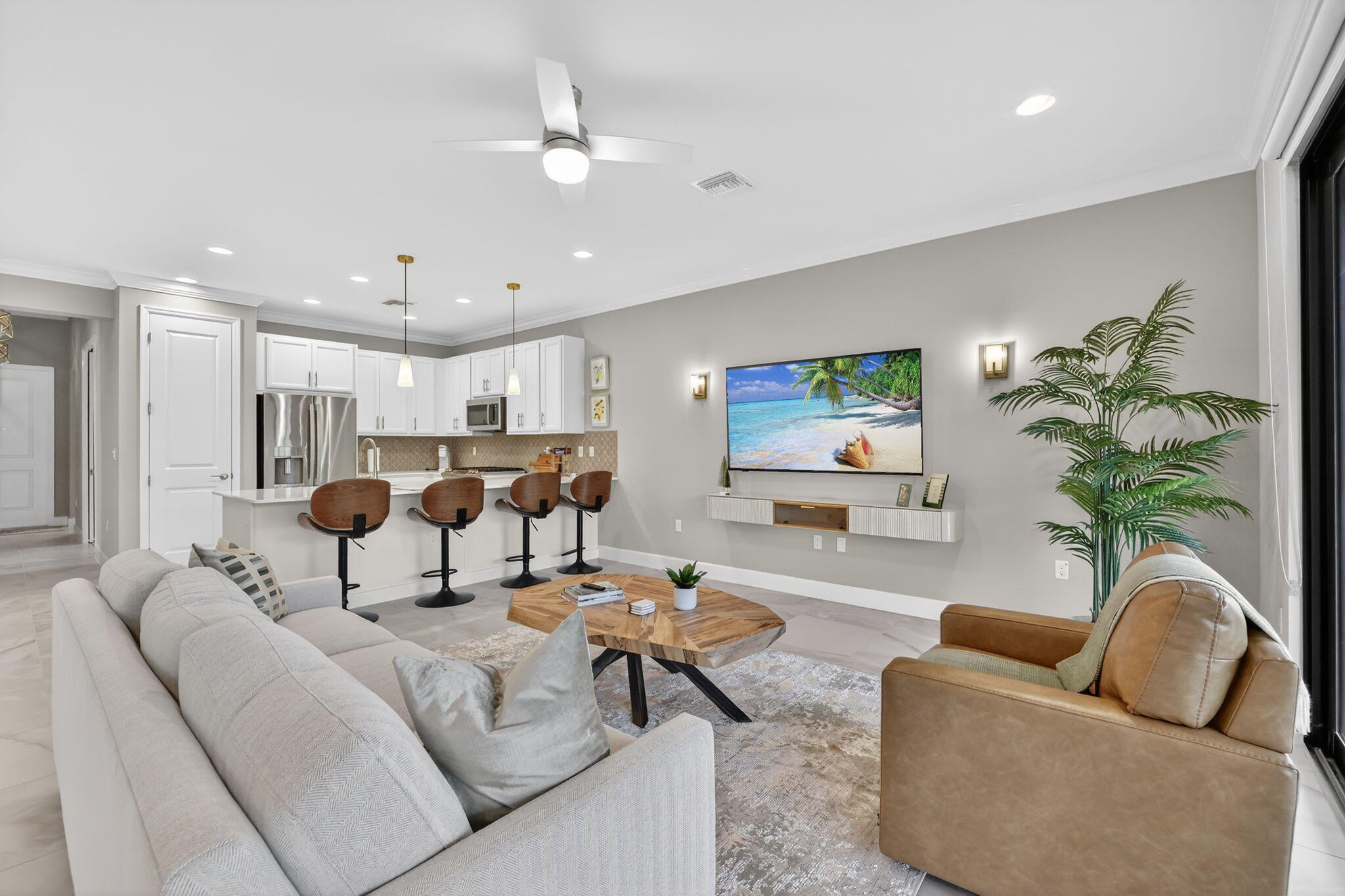 12447 Southwest Blue Mangrove Parkway Port St. Lucie, FL 34987 - Photo 12 of 80 a living room with furniture potted plant and a window
