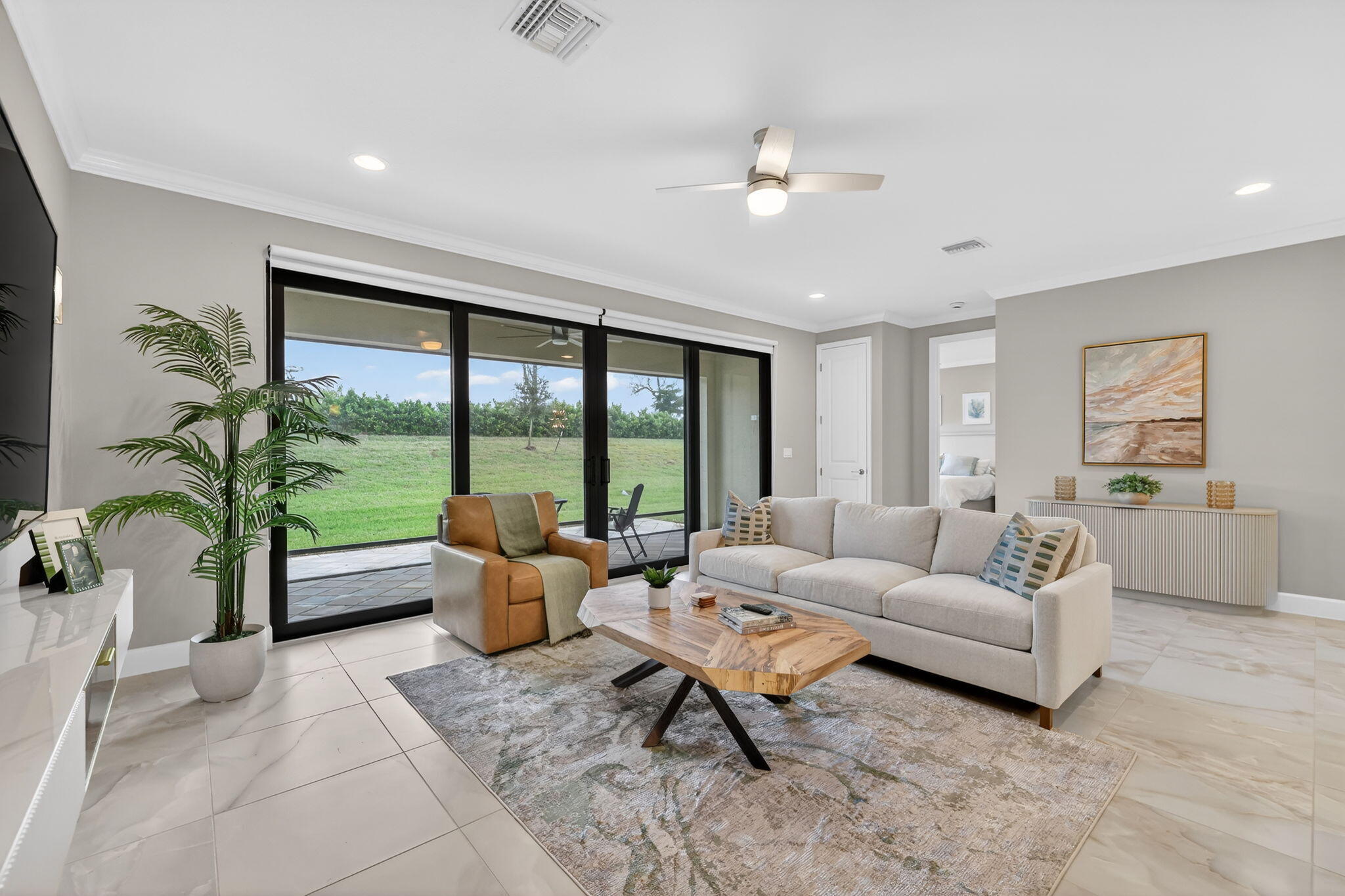 12447 Southwest Blue Mangrove Parkway Port St. Lucie, FL 34987 - Photo 13 of 80 a living room with furniture and floor to ceiling windows
