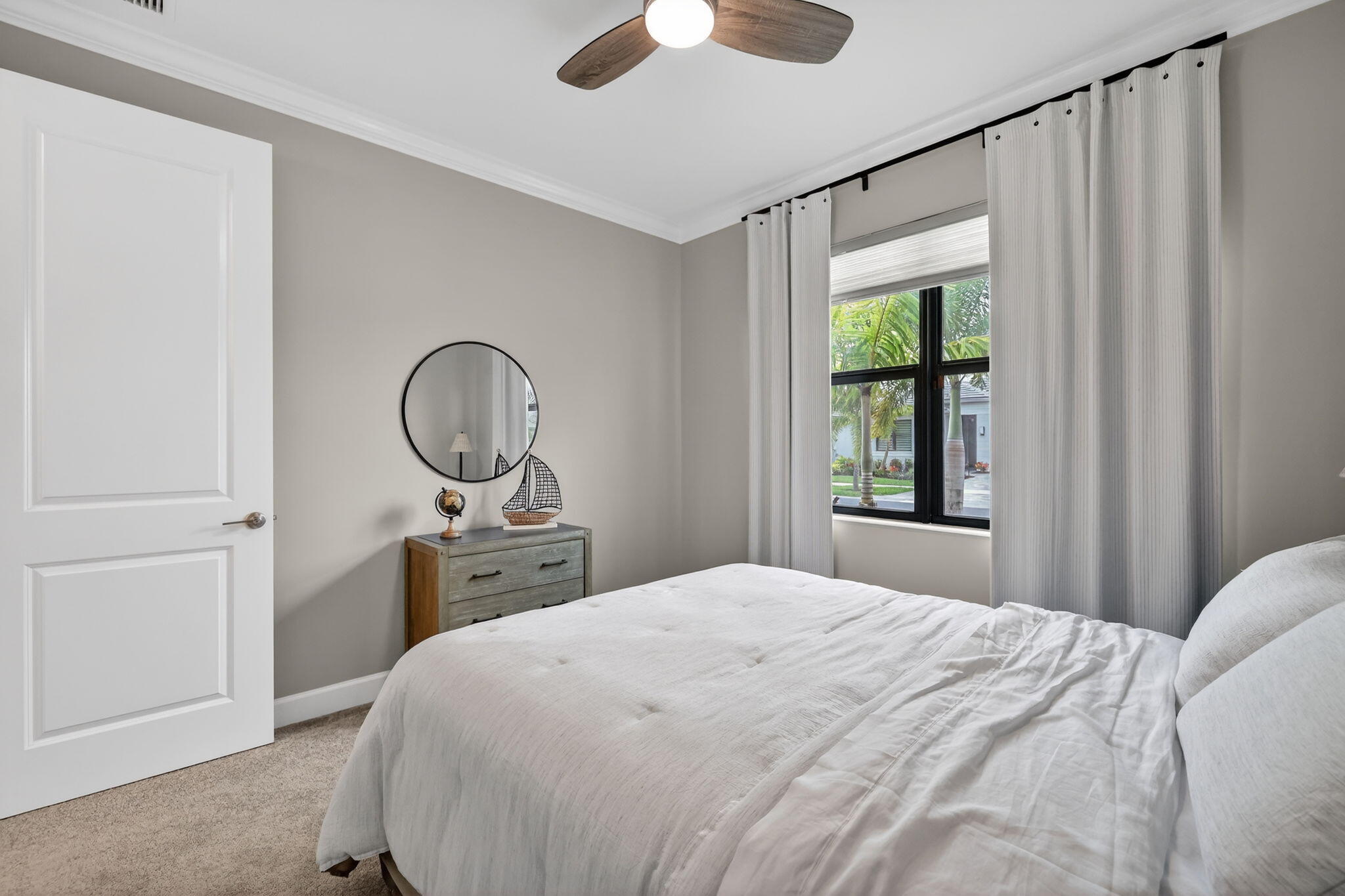 12447 Southwest Blue Mangrove Parkway Port St. Lucie, FL 34987 - Photo 16 of 80 a bedroom with a bed and a chandelier